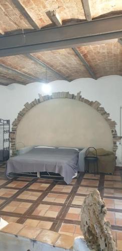 a bedroom with a bed in a brick wall at Casa fiabesca a Sperlonga in Sperlonga
