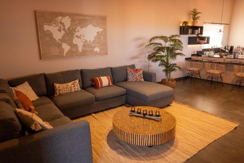 a living room with a couch and a table at Finca Roberto by Don Robertos Finca Paraíso in Parque Holandes