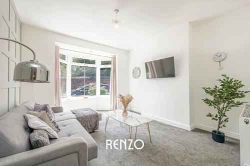a living room with a couch and a table at Cosy and Lovely 3-bed Home in Lincoln by Renzo, Free Wi-Fi, Sleeps 8! in Lincolnshire