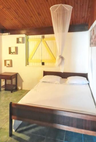 a bedroom with a large bed with a wooden ceiling at Maison de 2 chambres avec jardin clos et wifi a Ducos in Ducos