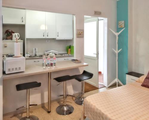 a kitchen with a counter and two stools in a room at Studio with wifi at Las Palmas de Gran Canaria 1 km away from the beach in Las Palmas de Gran Canaria