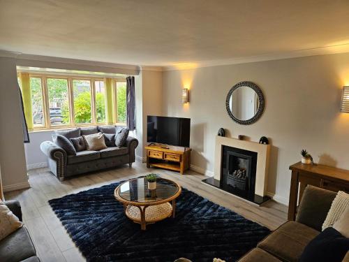 a living room with a couch and a fireplace at Redcot Gds Stamford 4 bed contractor,Disabled facilities home with Parking in Stamford