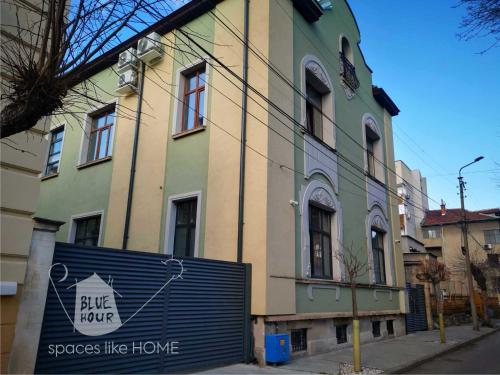 a building with a blue hope sign in front of it at Пространства за гости Синият час - апартамент The Glass Moon in Ruse