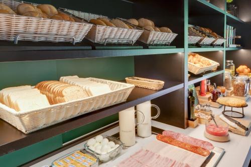 a bakery with bread and pastries on shelves at B&B HOTEL Barcelona Granollers in Les Franqueses del Vallès