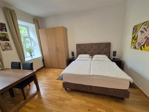 a bedroom with a large bed and a wooden floor at Sweet Dreams in Vienna