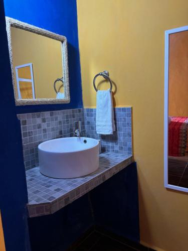 a bathroom with a white sink and a mirror at Capacabana in Bacalar