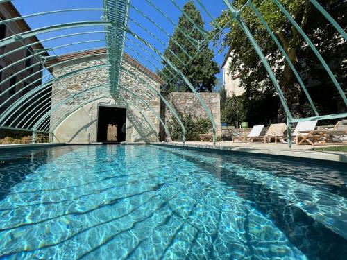 a swimming pool in a building at Villa Firmin Galimard - Gite de luxe avec Piscine in Vals-les-Bains