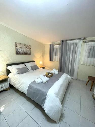 a bedroom with a large bed with towels on it at ARGO Downtown Apartment in Kalymnos