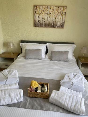 a bedroom with a bed with towels and a basket on it at ARGO Downtown Apartment in Kalymnos