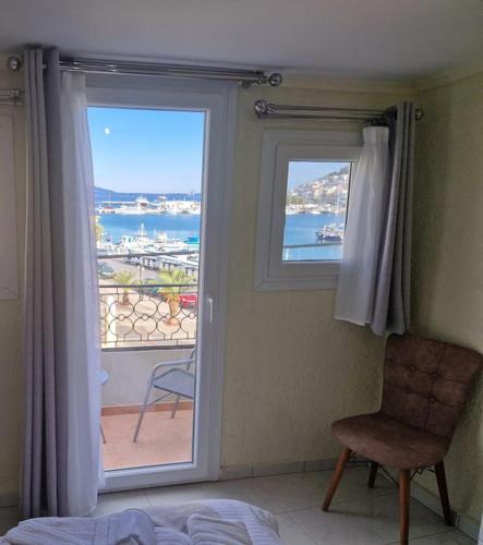 a bedroom with a window with a view of the ocean at ARGO Downtown Apartment in Kalymnos
