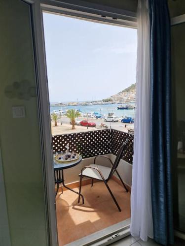a view of a balcony with a table and a chair at ARGO Downtown Apartment in Kalymnos