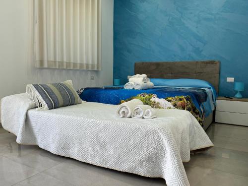 a bedroom with two beds with towels on them at Napul'è B&B in Boscotrecase