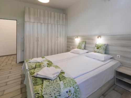 a bedroom with two beds and a cabinet at Home Gramatikovi in Pomorie