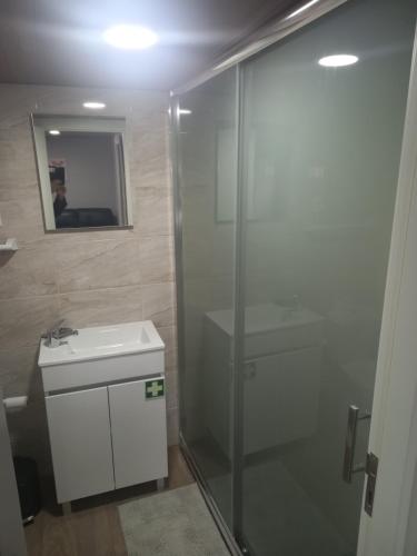 a bathroom with a shower and a sink and a mirror at Casa do Moinho in Resende