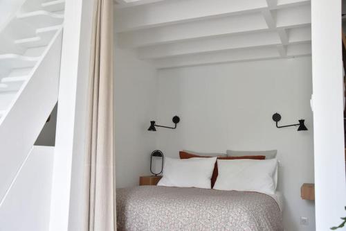 En eller flere senge i et værelse på Maison Source