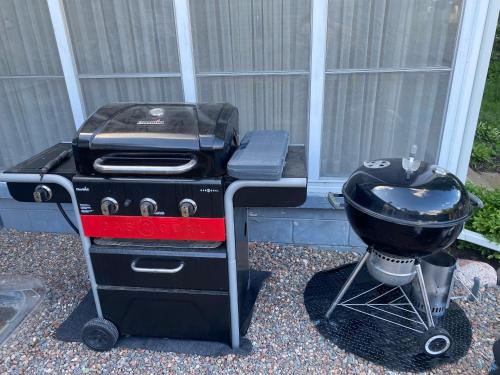 a grill and a bbq on a stand at Enchanting and comfy urban cottage with renovated rustic den by Como Park & MN State Fair in Saint Paul