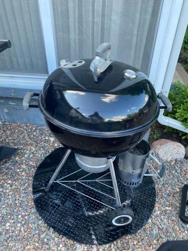 a bbq grill with a black grill at Enchanting and comfy urban cottage with renovated rustic den by Como Park & MN State Fair in Saint Paul