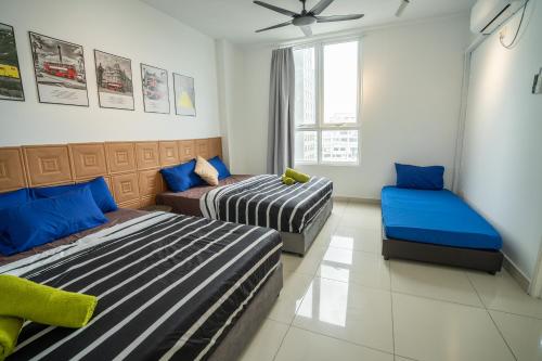 a bedroom with two beds and a couch at Georgetown Seaview MansionOne @Penang in George Town