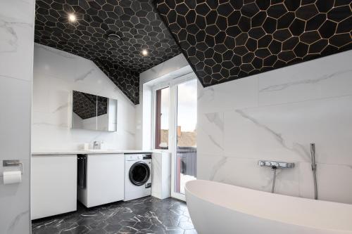 a bathroom with a sink and a washer and dryer at Posti villa 2 in Pärnu