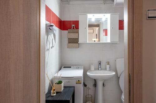a small bathroom with a sink and a toilet at Teo Apartment in Iraklitsa
