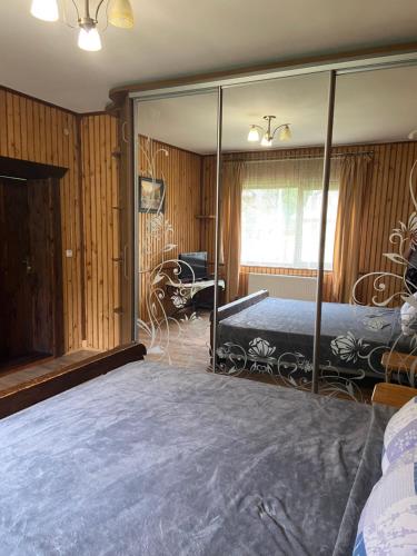 a bedroom with a bed with a large mirror at U Bogdana in Yaremche