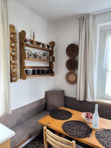 a dining room with a wooden table and chairs at Chata Rybná 18 in Pernink
