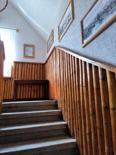 a set of stairs in a building with wood paneling at Chata Rybná 18 in Pernink