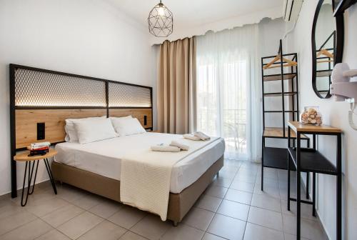 a bedroom with a large bed and a large window at Ioanna's House in Potos
