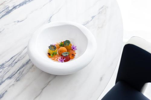 a white bowl of food on a marble counter at Bela Vista Hotel & Spa - Relais & Chateaux in Portimão