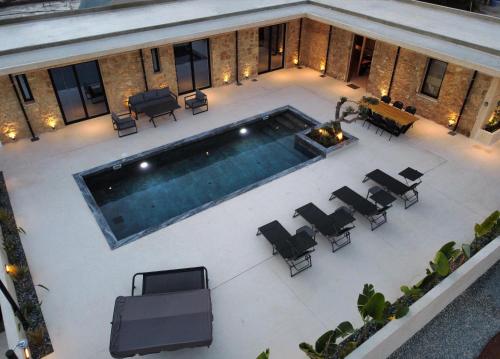 an overhead view of a swimming pool with chairs at Phaedrus Living Olive Grove Luxury Villa in Paphos