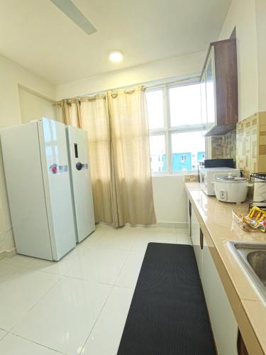 a kitchen with a white refrigerator and a window at Urban Stays by Empress in Hulhumale