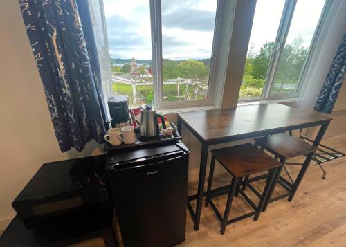 a kitchen with a table and a table and a window at The Edenwild Boutique Inn in Lopez