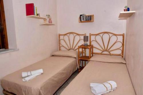 a room with two beds with towels on them at casa Maruzza in Casteldaccia