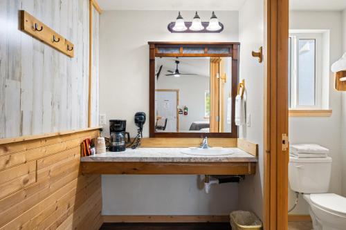 uma casa de banho com um lavatório e um espelho em Moose Inn em Spirit Lake