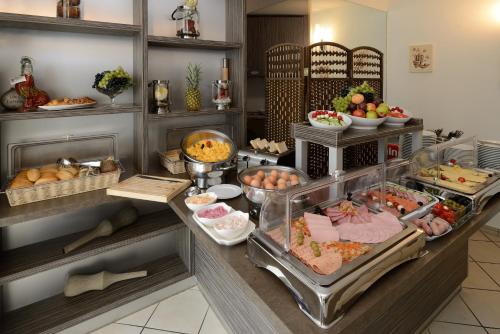 a buffet with many different types of food on display at Hotel Marienthal Garni in Hamburg