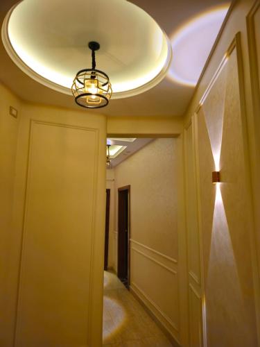 a hallway with a ceiling with a light at 3rd floor luxury apartment-families only in Alexandria