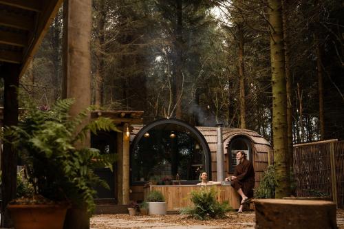 a man and a woman standing in front of a house at Galgorm in Ballymena