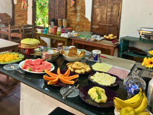 ein Tisch mit vielen verschiedenen Arten von Essen darauf in der Unterkunft Pousada e Restaurante Casinha Velha in Macacos