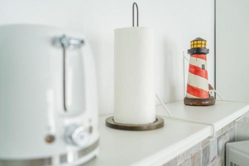 a bathroom counter with rolls of toilet paper and a flashlight at Casa Maja in Costa de Antigua