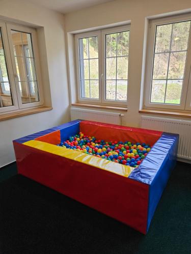 a play room with a large colorful couch with balls at Špindl Lodge Apartments Self check-in & Sauna in Špindlerův Mlýn