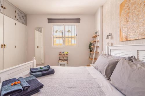 a bedroom with a large white bed and a window at Casa Maja in Costa de Antigua