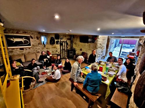 a group of people sitting in a living room at Albergue Casa do Sardão in Carreço