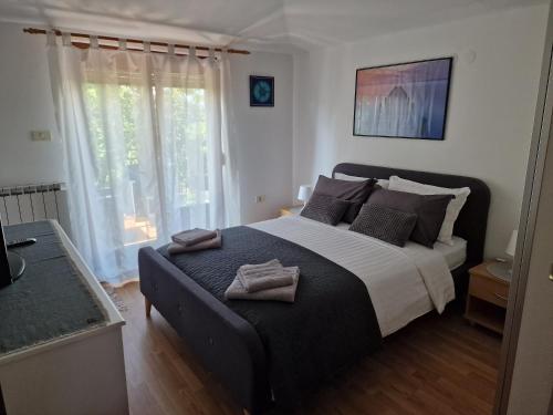 a bedroom with a large bed with two towels on it at Sea View Terrace Apartment Izola in Izola