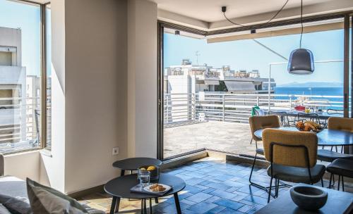 a room with a large window and a table and chairs at Wonder Apartment over the Sea in Athens