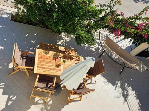 an overhead view of a table and chairs and an umbrella at TheYellow House Fully Equipped 2BR apartment in Pilaroú