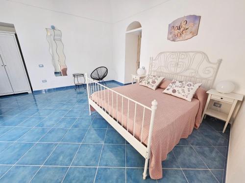 a bedroom with a bed and blue tile floors at Maridea - Marlin in Ponza