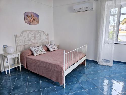 a bedroom with a bed with two pillows on it at Maridea - Marlin in Ponza