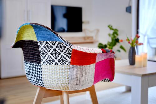 a colorful blanket on the back of a chair at Ferienwohnungen by Weingut Hommes in Ernst Mosel in Ernst