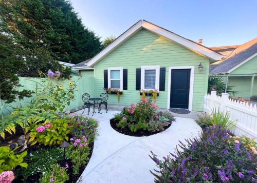 a green house with flowers in front of it at The Edenwild Boutique Inn in Lopez