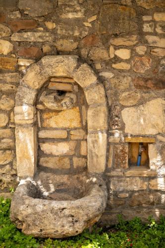 a stone building with a toilet in front of it at liofito village house in Pemónia